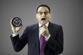 Stressed businessman with watch in hand. Man in panic, time management concept Royalty Free Stock Photo