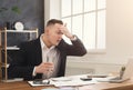 Stressed male manager working on laptop and drinking water Royalty Free Stock Photo