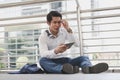 Stressed businessman worry financial bankruptcy. Depressed asian male sitting on the street tired after failed to rescue company