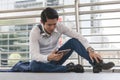 Stressed businessman worry financial bankruptcy. Depressed asian male sitting on the street tired after failed to rescue company