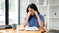 A stressed businesswoman is feeling overwhelmed, and having a serious conversation over the phone