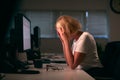 Stressed Businesswoman With Head In Hands Working Late At Computer In Office Royalty Free Stock Photo