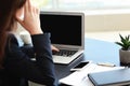 Stressed businesswoman with non-working laptop sitting at workplace in office