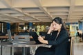 Stressed business woman sitting in office and using digital tablet. Royalty Free Stock Photo