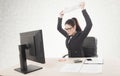 Stressed businesswoman sitting at table in front of computers.