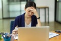 Stressed businesswomen working in office sit in front of laptop