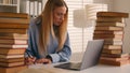 Stressed busy annoyed Caucasian student girl high school pupil woman stressful leaner studying with laptop and books Royalty Free Stock Photo