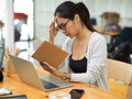 Stressed casual female with glasses worker looking on her schedule book Royalty Free Stock Photo