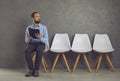 Stressed caucasian man feeling fear before job interview sitting on chair