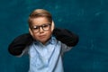 Stressed child wearing eyeglasses and shirt Royalty Free Stock Photo