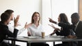 While stressed colleagues screaming to young businesswoman she meditating Royalty Free Stock Photo