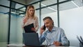 Stressed colleagues working laptop in corporate office. Ceo man solving problems Royalty Free Stock Photo