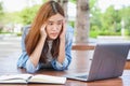 Stressed college student overwork reading final exam. female touching her head and having headache and eyes pain.