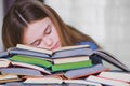 Stressed college student tired of hard learning with books in exams tests preparation Royalty Free Stock Photo