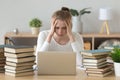Stressed college student tired of hard learning with books laptop Royalty Free Stock Photo