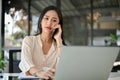 Stressed and confused millennial Asian businesswoman is on the phone, having a serious phone call Royalty Free Stock Photo