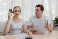 Stressed couple young family holding credit card for pay to so many expenses bills such as electricity bill,.water bill,internet Royalty Free Stock Photo