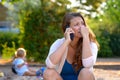 Stressed depressed mother talking on a mobile Royalty Free Stock Photo