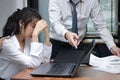 Stressed depressed young Asian business woman are being blamed with boss in workplace of office. Royalty Free Stock Photo