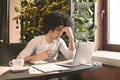 Stressed desperate man sitting in cafe with laptop