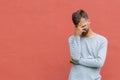 Stressed disappointed young guy making facepalm gesture with hand. Red wall background, copy space. Facepalm concept Royalty Free Stock Photo