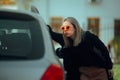 Woman Locked Out of her Car Looking Inside Confused Royalty Free Stock Photo