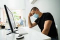 Stressed Employee In Office Wearing Mask