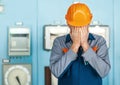 Stressed engineer closed face by two hands Royalty Free Stock Photo