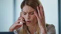 Stressed entrepreneur calling phone at workroom. Confused manager facepalming