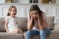 Stressed mother feeling desperate about screaming stubborn kid daughter tantrum Royalty Free Stock Photo