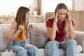 Stressed exhausted mother touching head, feeling desperate about screaming daughter Royalty Free Stock Photo