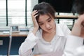 Stressed exhausted young Asian business woman suffering from severe depression between meeting in office. Royalty Free Stock Photo