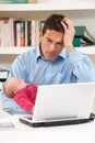 Stressed Father With Baby Working From Home Royalty Free Stock Photo