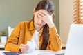 Stressed, fatigued. Tired asian young employee, business woman cover face with hand, calculate tax income and cost expenses, bills Royalty Free Stock Photo