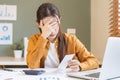 Stressed, fatigued. Tired asian young employee, business woman cover face with hand, calculate tax income and cost expenses, bills Royalty Free Stock Photo