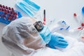 Stressed female doctor sitting tired at his desk. Mid adult female doctor working long hours in protective clothes Royalty Free Stock Photo