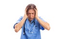 Stressed female hospital nurse grabbing head because of pain