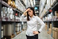 Stressed female manager in warehouse store