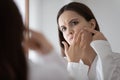 Stressed frowning teenage girl focused on beauty care problem Royalty Free Stock Photo