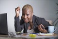 Stressed and frustrated afro American black woman working overwhelmed and upset at office laptop computer desk gesturing desperate