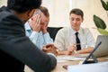 Stressed and frustrated Caucasian male CEO is in a meeting with financial consultants Royalty Free Stock Photo