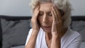 Stressed frustrated elderly woman feeling strong painful headache Royalty Free Stock Photo