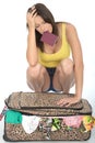 Stressed Frustrated Fed Up Young Woman Trying to Close Her Suitcase Royalty Free Stock Photo