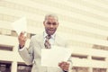 Stressed frustrated man holding looking at documents