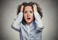 Stressed, frustrated shocked business woman pulling hair out