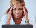 Stressed, frustrated and unhappy business woman suffering from a headache or migraine and feeling tired at the office Royalty Free Stock Photo
