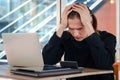 Stressed frustrated young businessman putting his head in his hand thinking about his job, feeling disappointed or tired camera Royalty Free Stock Photo