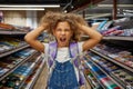 Stressed girl child feeling crazy during shopping at stationery shop Royalty Free Stock Photo