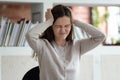 Stressed girl closed eyes touch head having terrible headache Royalty Free Stock Photo