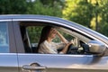 Stressed girl with headache drive car. Frustrated displeased young female driver suffer from illness Royalty Free Stock Photo